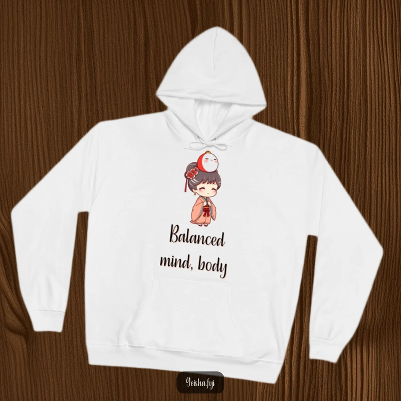 Funny Geisha Hoodie: A charming geisha character is depicted humorously balancing a miniature Daruma doll on her head, offering cozy laughs.